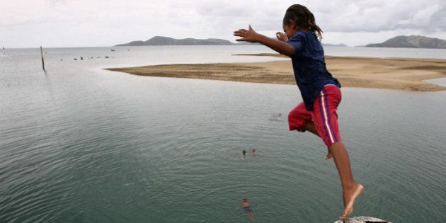 (AUSTRALIA & NEW ZEALAND OUT) Local children fill in their spare time by jumping off the pier on Palm Island in northern Queensland, 18 January 2007. THE AGE Picture by PAUL HARRIS (Photo by Fairfax Media/Fairfax Media via Getty Images)