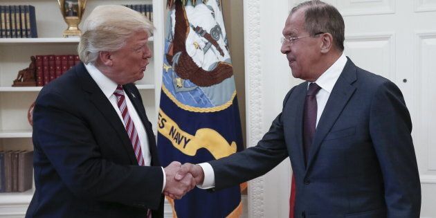 President Donald Trump shakes hands with Russian Foreign Minister Sergei Lavrov as they meet for talks in the Oval Office at the White House.