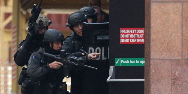 SYDNEY, AUSTRALIA - DECEMBER 15: Armed police are seen outside the Lindt Cafe, Martin Place on December 15, 2014 in Sydney, Australia. Police attend a hostage situation at Lindt Cafe in Martin Place. (Photo by Mark Metcalfe/Getty Images)