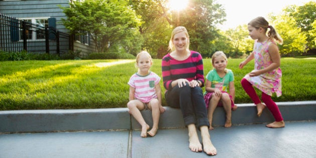 Portrait of babysitter and little girls