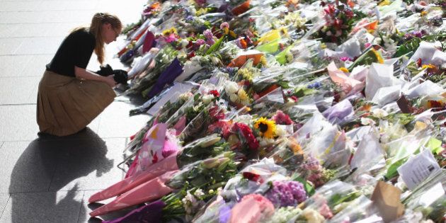 SYDNEY, AUSTRALIA - DECEMBER 17: Flowers are left as a sign of respect at Martin Place on December 17, 2014 in Sydney, Australia. Sydney siege gunman Man Haron Monis, was shot dead by police in the early hours of Tuesday morning after taking hostages at the Lindt Chocolat Cafe in Martin Place. Two other people died, 33-year-old cafe manager Tori Johnson and 38-year-old Sydney barrister Katrina Dawson. (Photo by Joosep Martinson/Getty Images)