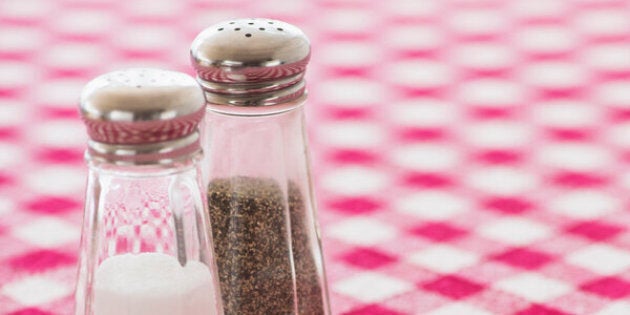 Salt and pepper shakers on checked tablecloth