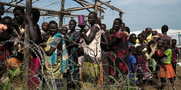 South Sudanese women and children queue to receive emergency food at the United Nations protection of civilians (POC) site 3.