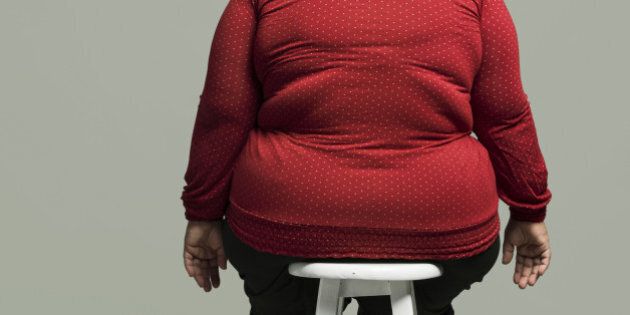 Obese woman on chair, rear view
