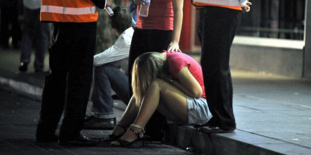 SYDNEY, AUSTRALIA - OCTOBER 12: (EUROPE AND AUSTRALASIA OUT) An intoxicated female is attended to by a friend on the street in Kings Cross on October 12, 2008 in Sydney, Australia. (Photo by Brad Hunter/Newspix/Getty Images)