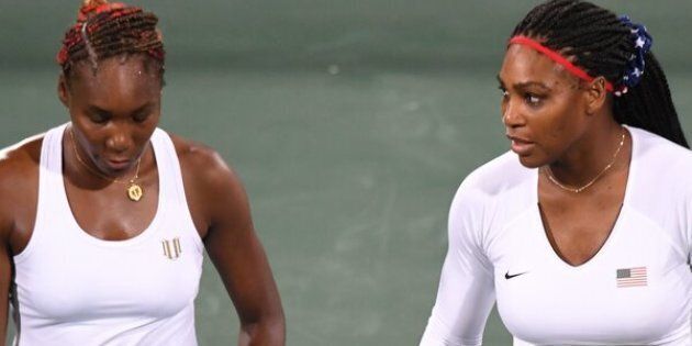 Serena Williams speaks to Venus Williams during their women's first round doubles tennis match against the Czech Republic's Lucie Safarova and Barbora Strycov.