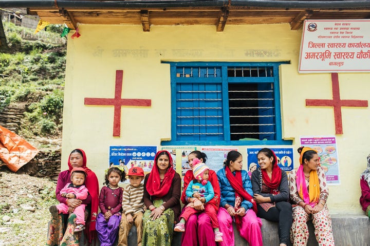 Mothers sit outside a birthing clinic, Nepal.