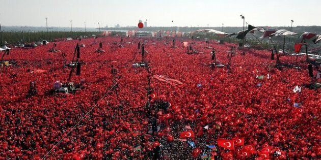 People hold Turkish flags as they take part in Democracy and Martyrs' Rally, held to protest against the July 15 failed coup, in Istanbul.