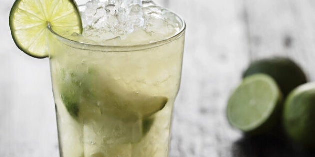 Caipirinha on wood table with lime decoration