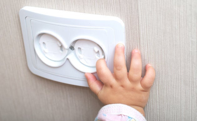 Covering power points with plugs protects little fingers.