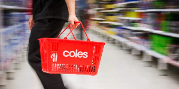 A shopper carries a basket while walking through a Coles supermarket, operated by Wesfarmers Ltd., in Sydney, Australia, on Tuesday, Feb. 18, 2014. Wesfarmers, Australia's largest employer, is scheduled to report first-half earnings on Feb. 19. Photographer: Ian Waldie/Bloomberg via Getty Images