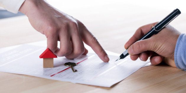 New homeowner signing contract of house sale or mortgage papers