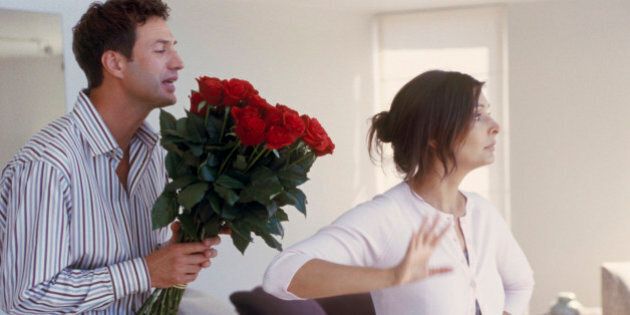View of a woman refusing roses from boyfriend