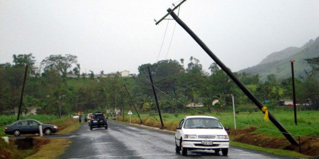 NADUNA, FIJI - MARCH 16 : (EUROPE AND AUSTRALASIA OUT) Poles carrying power lines lean precariously along Vaturekuka road in Labasa, Fiji, after Cyclone Tomas struck the Pacific island group. The category four cyclone struck Fiji's eastern Lau group of islands, with winds averaging 175 kilometres an hour. (Photo by Theresa Ralogaivau/Newspix/Getty Images)