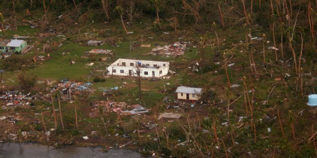 In this Sunday, Feb. 21, 2016 aerial photo supplied by the New Zealand Defense Force, debris is scattered around damaged buildings at Muamua on Vanua Blava Island in Fiji, after Cyclone Winston tore through the island nation. Fijians were finally able to venture outside Monday after authorities lifted a curfew but much of the country remained without electricity in the wake of a ferocious cyclone that left at least six people dead and destroyed hundreds of homes. (New Zealand Defense Force via AP) EDITORIAL USE ONLY
