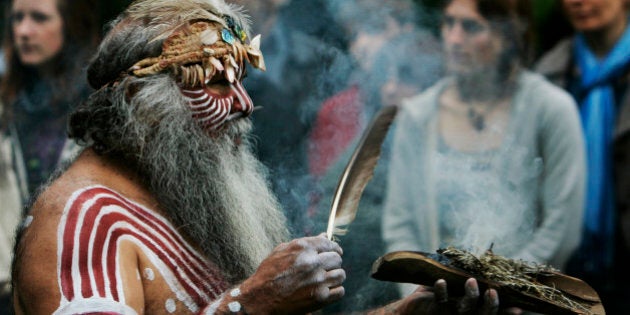 Aboriginal Ngarrindjeri elder Major Sumner from south Australia, in traditional costume, performs a ritual during a ceremony to mark the return of Australian indigenous people's remains back to their homeland, in a central London park, Thursday May 14, 2009. A skull and other bone fragments uncovered in the basement of an elderly British academic's home have been handed over to the Australian government in a solemn Aboriginal ceremony held in a central London park. They're the latest batch of bones to be returned to the country, part of Australia's ongoing effort to recover Aboriginal remains scattered in museums and hidden away in cupboards all over the world. (AP Photo/Lefteris Pitarakis)