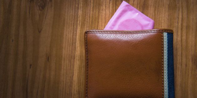 Condom put inside man wallet, Save sex concept