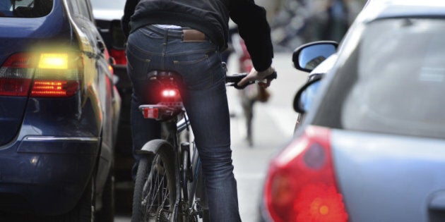 Male bicyclist in heavy traffic