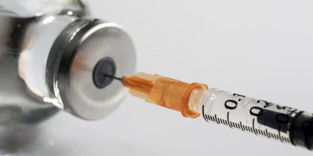 macro photography of a syringe ready to put a vaccine