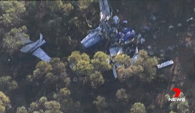 Footage taken from a Channel 7 helicopter shows the mangled wreck of the light plane which crashed with three people on-board on Tuesday night.