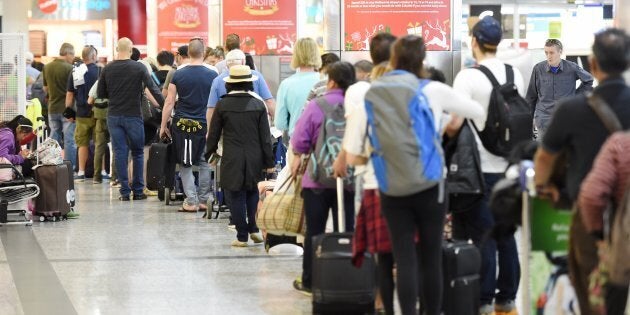 Massive queue of travellers waiting to go through international departure doors due to strike action by Border Force workers at Melbourne Airport in November 2015.