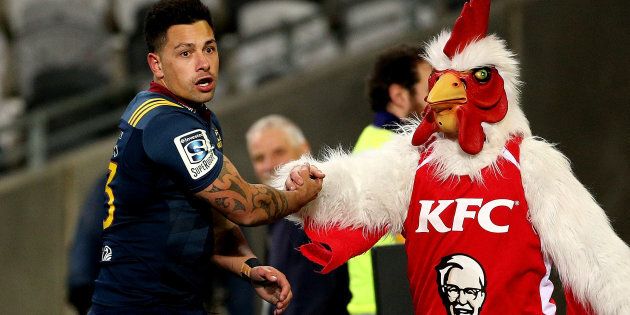 The Highlanders' Rob Thompson celebrates his try with the KFC mascot in a Super Rugby Match in Dunedin.