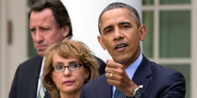 In this photo from Wednesday, April 17, 2013, Neil Heslin, father of six-year-old Newtown victim Jesse Lewis, left, and former Rep. Gabby Giffords, D-Ariz., stands by President Barack Obama as he gestures while speaking during a news conference in the Rose Garden of the White House in Washington. In past five years, Giffords has hiked the Grand Canyon, raced in a 40-mile bike ride, sky dived and founded an advocacy group that helped convince President Obama to take executive action on gun control. (AP Photo/Jacquelyn Martin)