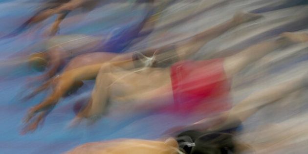 RIO DE JANEIRO, BRAZIL - AUGUST 11: Competitors dive into the water in heat five of the Men's 50m Freestyle on Day 6 of the Rio 2016 Olympic Games at the Olympic Aquatics Stadium on August 11, 2016 in Rio de Janeiro, Brazil. (Photo by Elsa/Getty Images)