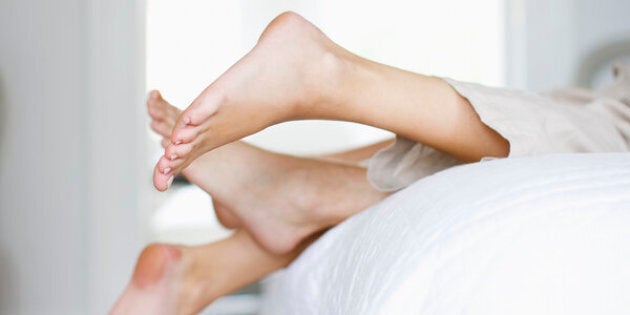 Couple laying on bed together