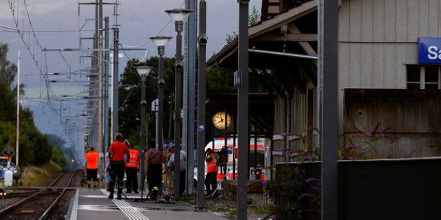 Workers clean a platform after a 27-year-old Swiss man's attack on a Swiss train at the railway station in the town of Salez, Switzerland August 13, 2016.