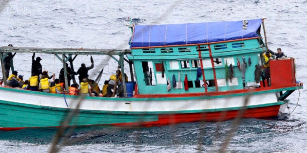 In this photo taken on April 14, 2013, a fishing boat carrying Vietnamese asylum seekers nears the shore...