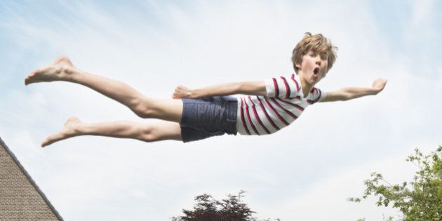 Kid flying through the air like superman