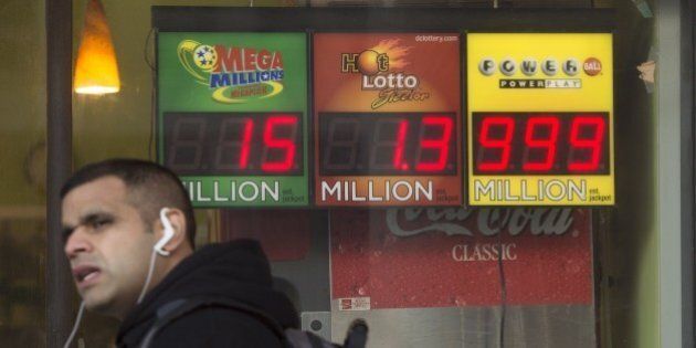 A man walks past a sign showing a Powerball prize of $999 million, the largest jackpot winnings that the Powerball sign can display, with the actual Powerball jackpot estimated at $1.3 billion, outside a deli in Washington, DC, January 11, 2016. The jackpot for the US Powerball lottery rose to a whopping $1.3 billion (1.19 billion euros) on January 10, by far the largest in US history, after organizers said there was no winner in the weekend draw. The Powerball prize rocketed to $950 million on Saturday, fueling a frenzy of lotto ticket buying across the United States. Numbers were drawn and announced late Saturday at 10:59 pm (0359 GMT Sunday) -- but hours later lottery officials said there was no winner. AFP PHOTO / SAUL LOEB / AFP / SAUL LOEB (Photo credit should read SAUL LOEB/AFP/Getty Images)