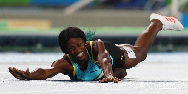 Shaunae Miller winces as she dives across the finish line.