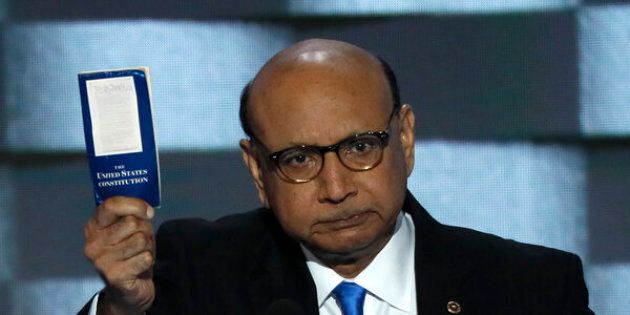 Khizr Khan, whose son, Humayun S. M. Khan was one of 14 American Muslims who died serving in the U.S. Army in the 10 years after the 9/11 attacks, offers to loan his copy of the Constitution to Republican U.S. presidential nominee Donald Trump, as he speaks while a relative looks on during the last night of the Democratic National Convention in Philadelphia, Pennsylvania, U.S. July 28, 2016. REUTERS/Mike Segar