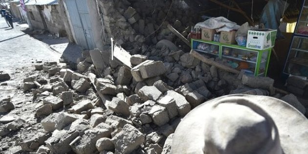 A woman observes the damage in her home on August 15, 2016 in the Andean town of Yanque in southern Peru caused by a 5.3 magnitude earthquake that struck this remote picturesque region in the state of Arequipa on Sunday night.At least four other people also died and 68 were injured, most by toppling buildings. Rescue and aid efforts have been hampered by more than 60 replica aftershocks that have rocked the area, which is popular with tourists, in the past 24 hours. / AFP / Jose Sotomayor Jimenez (Photo credit should read JOSE SOTOMAYOR JIMENEZ/AFP/Getty Images)