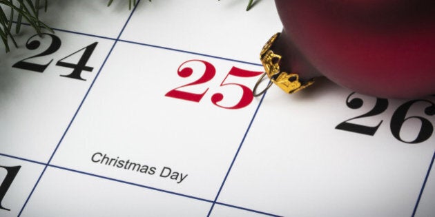 Close up of calendar on December 25th, Christmas day, with evergreens and an ornament