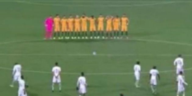 The Socceroos stand in a row, observing a minute's silence for the eight victims of the London Bridge terror attack.