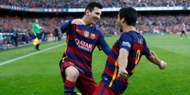 FC Barcelona's Luis Suarez, right, reacts after scoring with his teammate Lionel Messi against Atletico Madrid during a Spanish La Liga soccer match at the Camp Nou stadium in Barcelona, Spain, Saturday, Jan. 30, 2016. (AP Photo/Manu Fernandez)