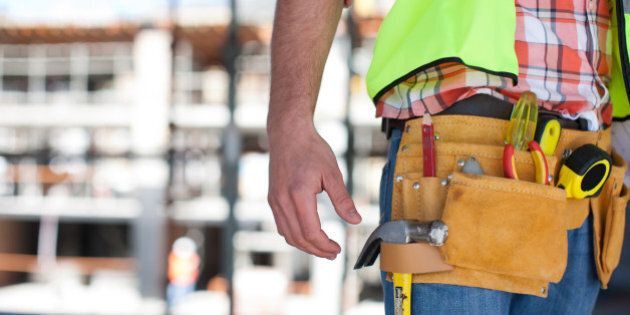 Close up of construction workerÂs tool belt on construction site