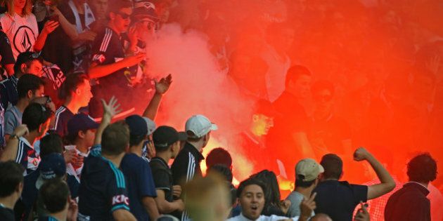 MELBOURNE, AUSTRALIA - FEBRUARY 13: A flare is ignited in the Melbourne Victory supporters area of the crowd during the round 19 A-League match between Melbourne City FC and Melbourne Victory at AAMI Park on February 13, 2016 in Melbourne, Australia. (Photo by Scott Barbour/Getty Images)