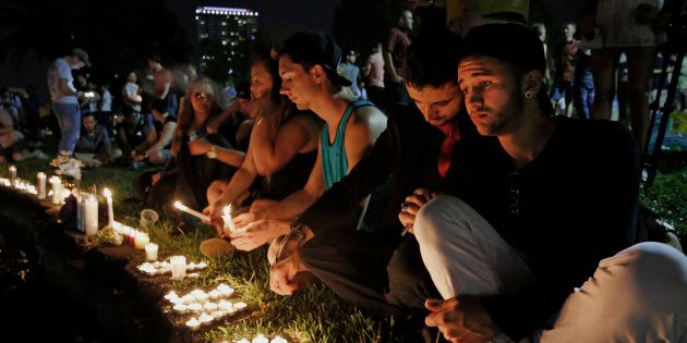 ORLANDO, FL - JUNE 12: Johnpaul (one word) Vazquez, right, and his boyfriend Yazan Sale, sit by Lake Eola, in downtown Orlando thinking of those killed and injured. 'We were supposed to go to the club last night, but I didn't feel right,' said Vazquez. Fifty people were killed and more than 50 others injured in a mass shooting at Pulse nightclub, located at 1912 S. Orange Ave., Orlando, Florida in the worst mass shooting in American history. Twenty-year-old Omar Mateen of Port St. Lucie, identified as the shooter. (Photo by Carolyn Cole/Los Angeles Times via Getty Images)