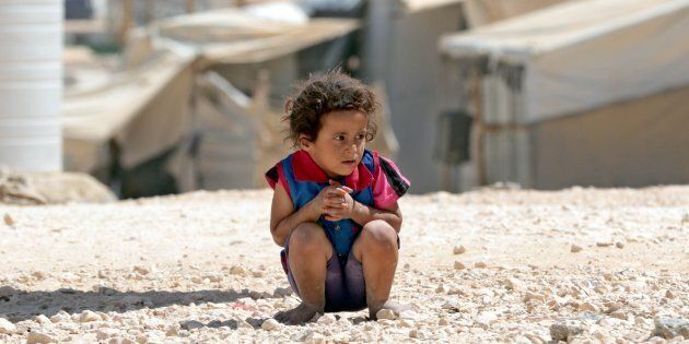 This is no normal life: a young syrian child plays in the dirt at Za’atari refugee camp.