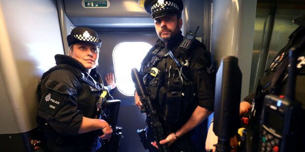 Armed police patrol trains in Britain for the first time after the terror threat was elevated to 'critical'.