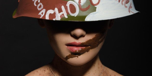 Beautiful woman with chocolate helmet, camouflage and badge on the neck