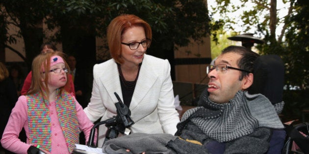 MELBOURNE, AUSTRALIA - MAY 01: Australian Prime Minister Julia Gillard meets Sophie Dean (L) and Dr George Taleporos (R) from the disabled community after a press conference at the Commonwealth Parliamentary Office on May 1, 2013 in Melbourne, Australia. Gillard has announced that the Federal Government will increase the Medicare levy on income tax from 1.5 to two percent to help fund the National Disability Insurance Scheme (NDIS). The levy will begin on July 1, 2014 and is expected to raise around $3.2 billion annually towards the NDIS which is expected to cost $8 billion per year. (Photo by Robert Cianflone/Getty Images)