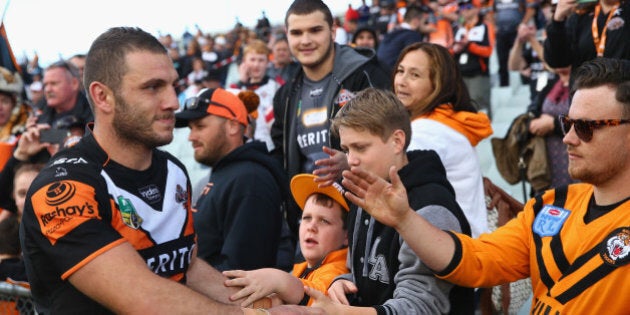 SYDNEY, AUSTRALIA - AUGUST 30: Robbie Farah of the Wests Tigers high fives the crowd after the Tigers last home game of the season during the round 25 NRL match between the Wests Tigers and the New Zealand Warriors at Campbelltown Sports Stadium on August 30, 2015 in Sydney, Australia. (Photo by Mark Kolbe/Getty Images)