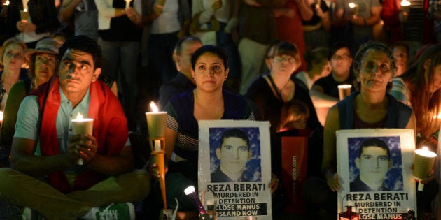 People attend a candlelight vigil in support of asylum seekers, in Sydney on February 23, 2014. Hundreds of people participated in the candlelight vigil in the major cities of Australia in response to the death of 23-year-old Iranian man Reza Berati who died in a detention centre on Manus Island on February 18. AFP PHOTO / Muhammad Farooq (Photo credit should read Muhammad Farooq/AFP/Getty Images)