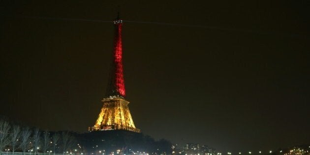 A picture taken on March 24, 2016 shows the Eiffel Tower in Paris illuminated in colours of the Belgian flag in tribute to the victims of terrorist attacks in Brussels, two days after a triple bomb attack, claimed by the Islamic State group, hit Brussels' airport and the Maelbeek - Maalbeek metro station, killing 31 people and wounding 300 others. / AFP / LUDOVIC MARIN (Photo credit should read LUDOVIC MARIN/AFP/Getty Images)