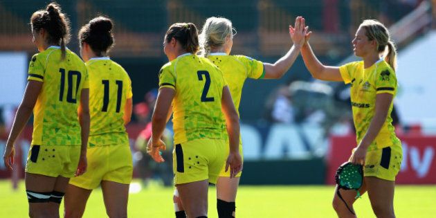 DUBAI, UNITED ARAB EMIRATES - DECEMBER 04: Emma Tonegato of Australia is congratulated by her team mates after the game against France during the IRB Women's Sevens Rugby World Series at the Emirates Dubai Rugby Sevens on December 4, 2014 in Dubai, United Arab Emirates. (Photo by Warren Little/Getty Images)
